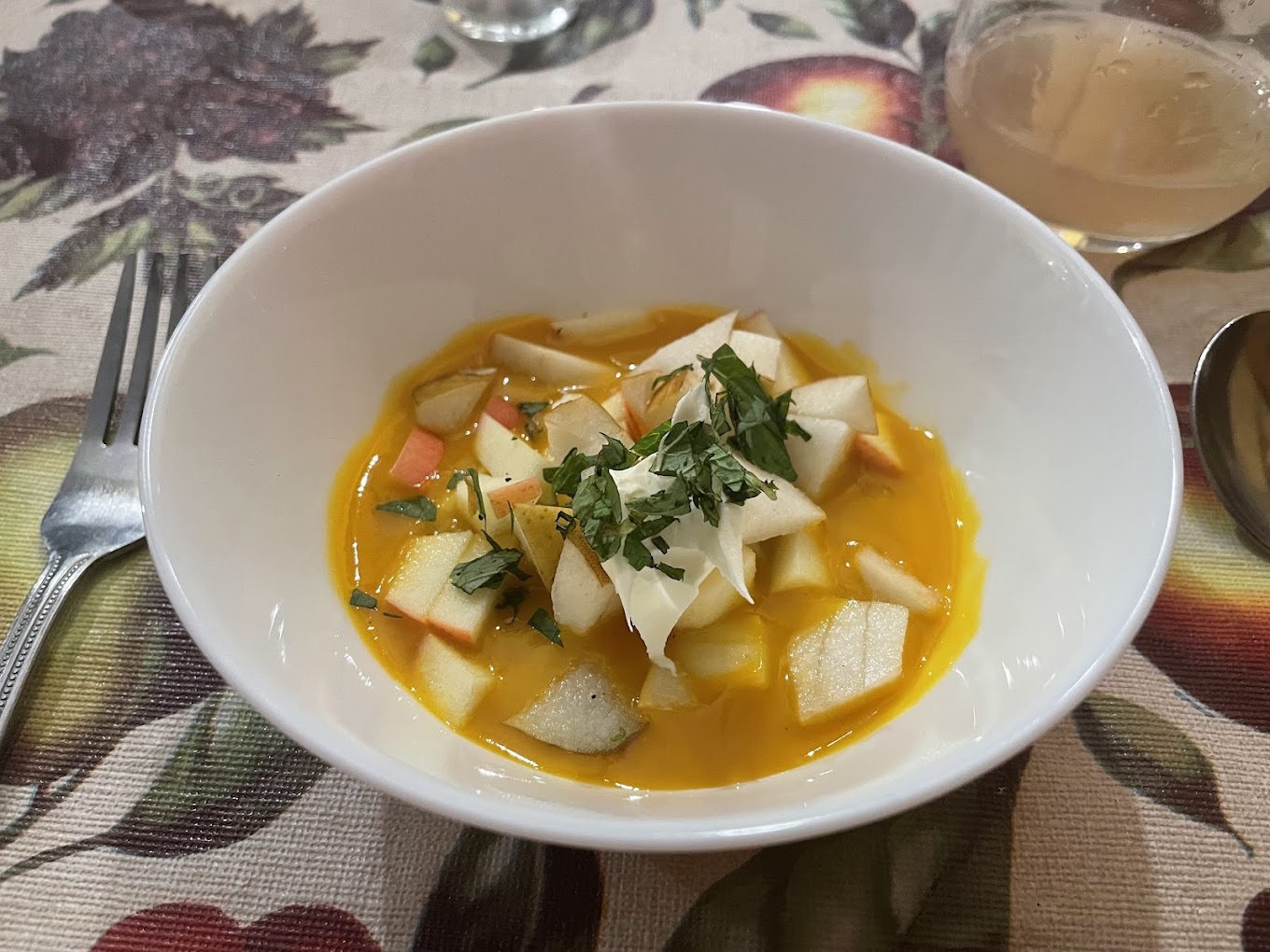 A seasonal soup with pears in a golden broth