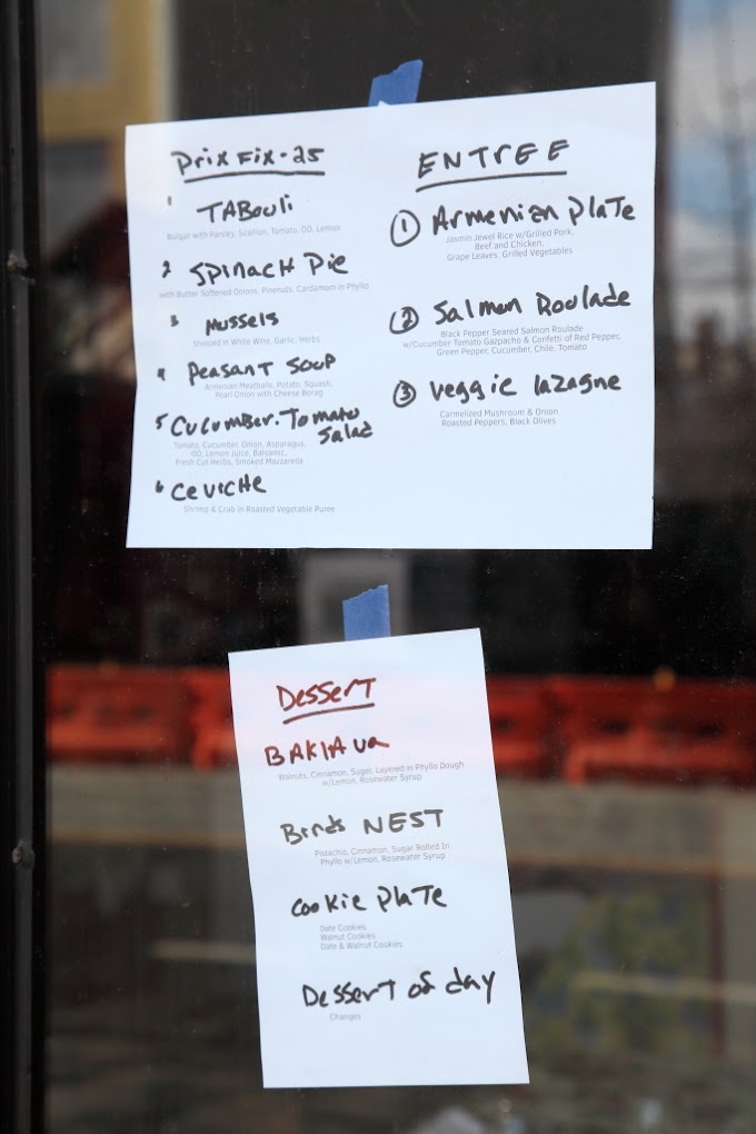 Handwritten prix fixe menu posted in the window at Cafe Little Armenia